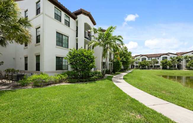 the preserve at city center walkway in front of apartment buildings and a lake