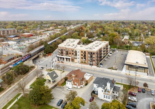 an aerial view of a city street with buildings and a train