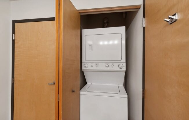 an empty laundry room with a washer and dryer