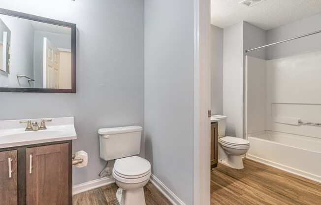 a bathroom with a toilet and a sink and a shower