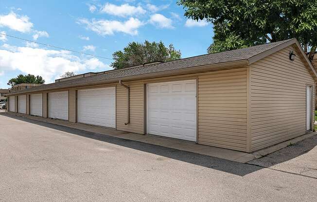 a row of garages with white doors