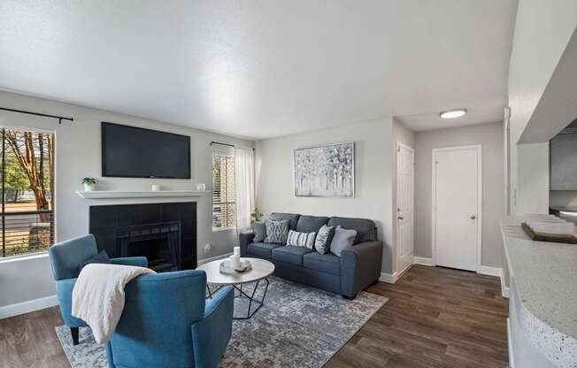 a living room with a fireplace and a tv