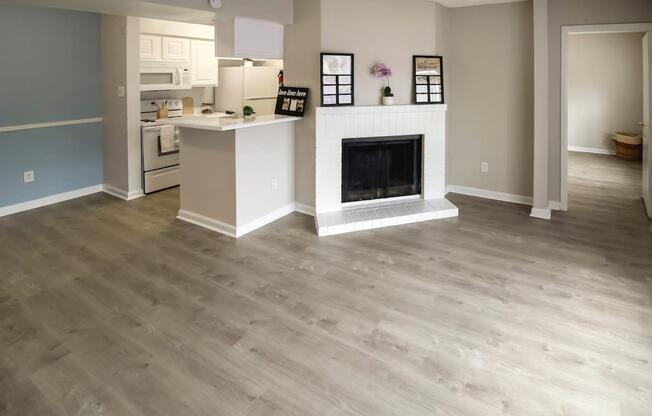 a living room with a fireplace and a wooden floor