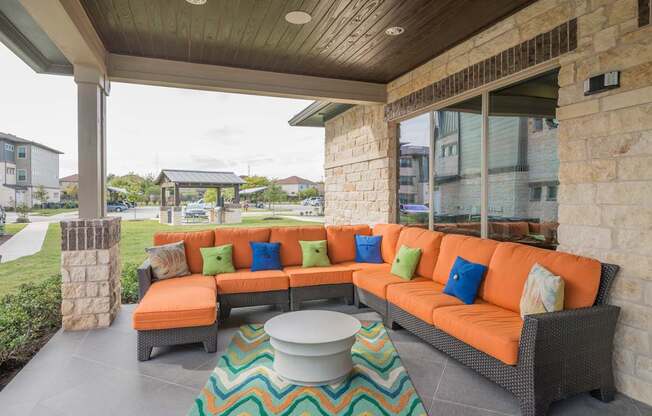 A patio with a sofa and a table.