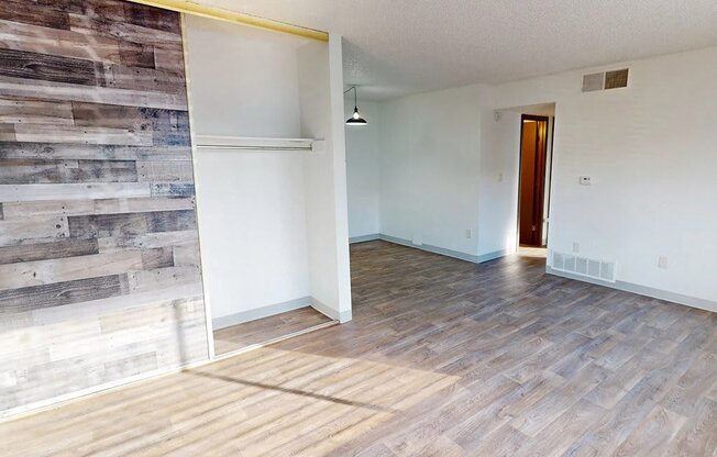 a living room with a wood syle floor and a sliding glass door