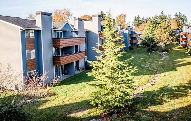A view of apartment buildings with a green lawn in front. at Northpoint Apartments, Washington, 98407