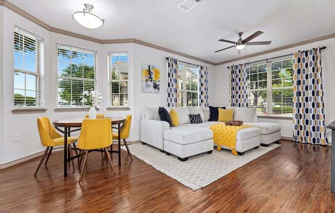 a living room with a couch and a table with chairs