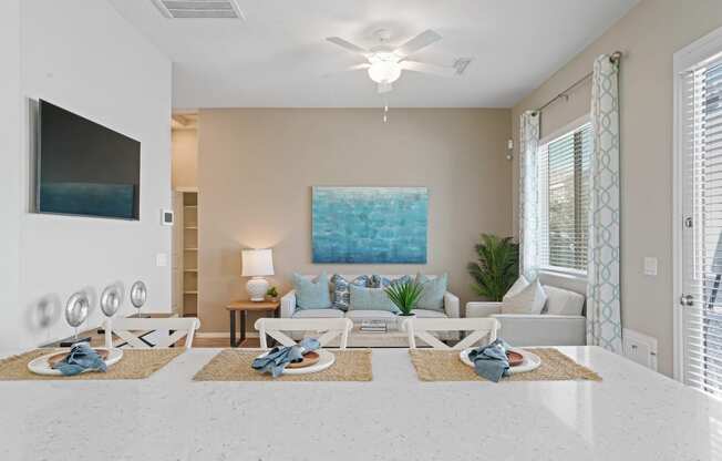 a living room with a couch and a ceiling fan