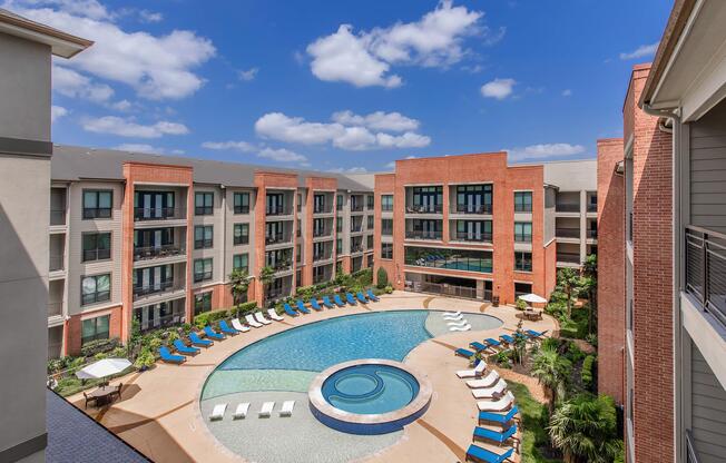 a large brick building with a pool