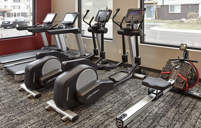 a group of exercise machines in a gym