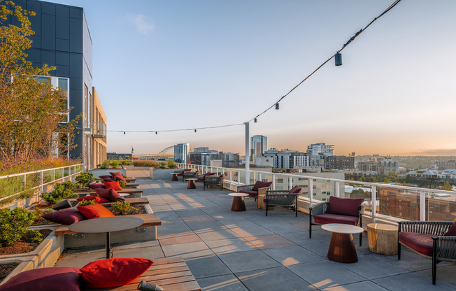 Lavish rooftop sundeck with armchair resort-style seating and sweeping views of Portland