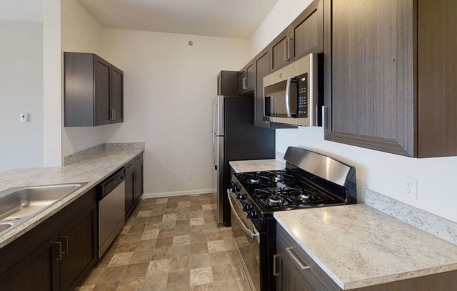 a two bedroom kitchen with stainless steel appliances