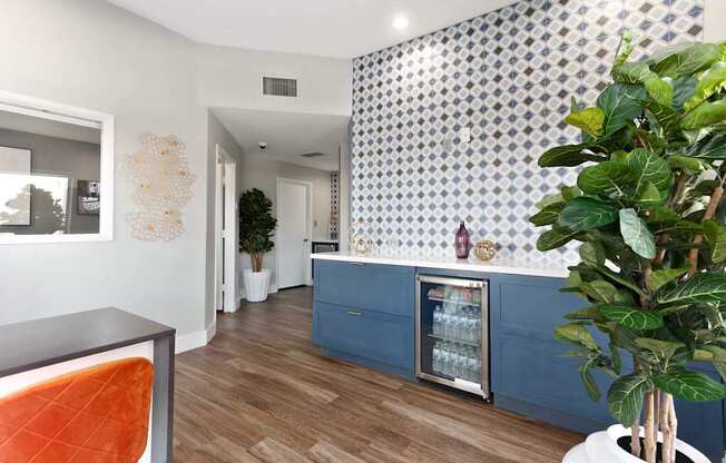 A room with a blue counter and a potted plant.