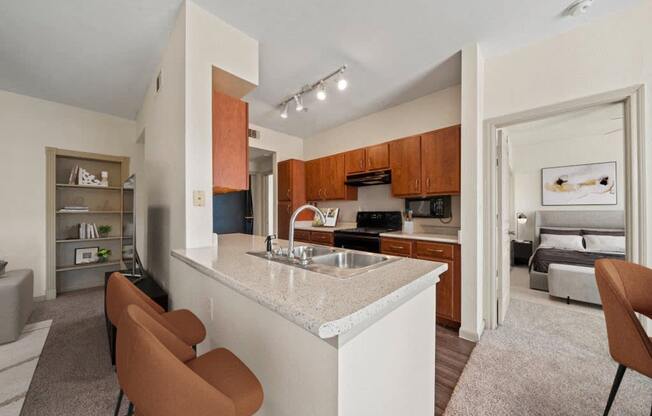 a view of a kitchen with a bar and a living room