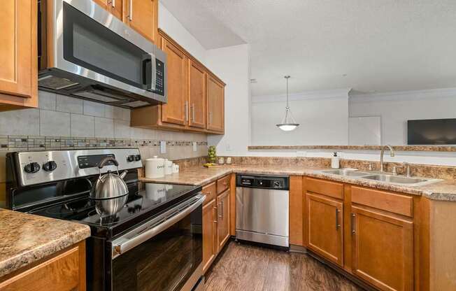 A kitchen with wooden cabinets and a black stove top oven.