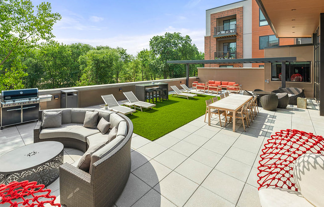 Roof-top terrace with grill, fire pits, and lounge area at Exton apartments Keva Flats