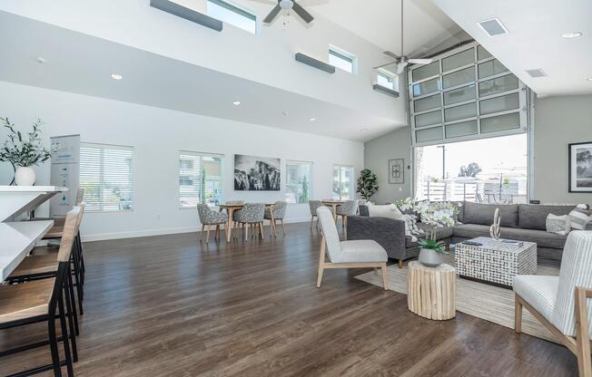 a living room filled with furniture and a large window