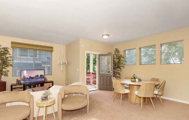 A living room with a couch, chairs, and a television at The Landing Apartments and Townhomes, Oregon, 97045