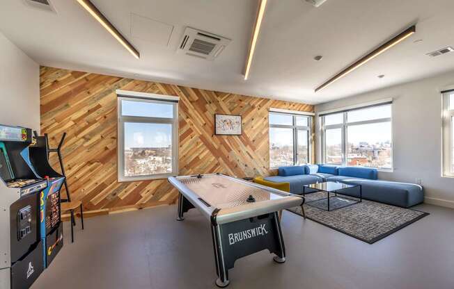 A room with a wooden wall and a pool table.