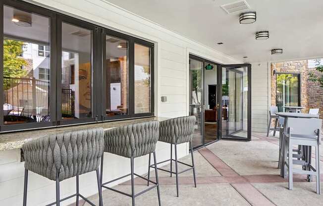 Two grey chairs are placed on a patio.