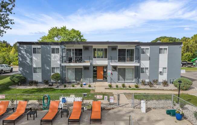 A sunny day at the outdoor pool area of a modern apartment complex.