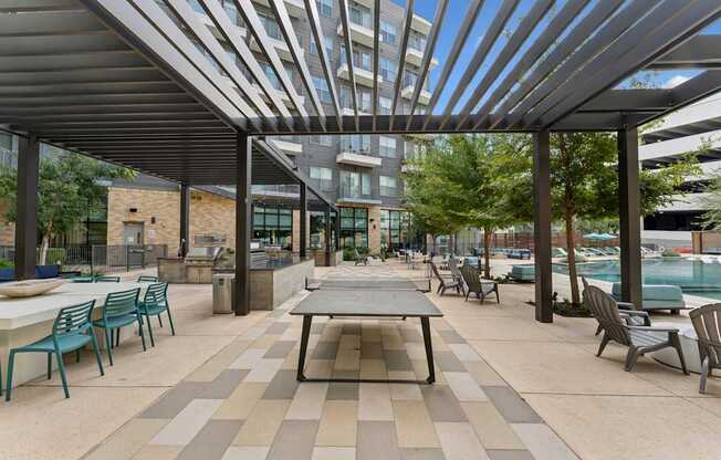 A patio with a table and chairs under a roof.