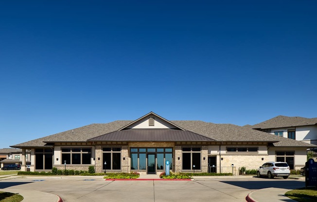 A building with a grey roof and a blue sky in the background.