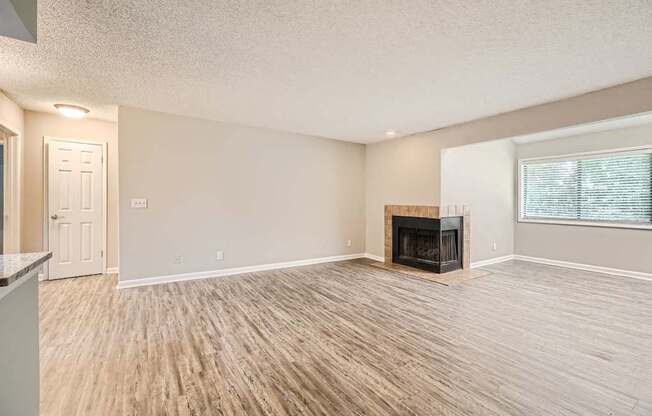 A living room with a fireplace and hardwood floors.