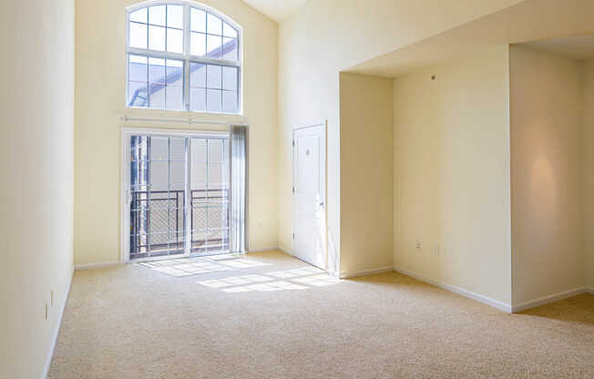 Carpeted Living Room with Balcony