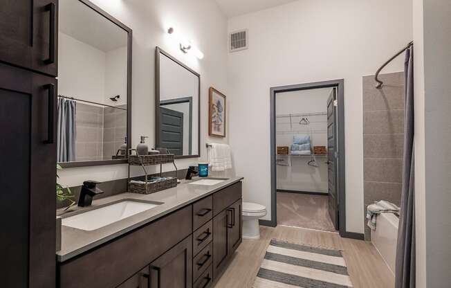 a bathroom with a sink and a shower and a toilet