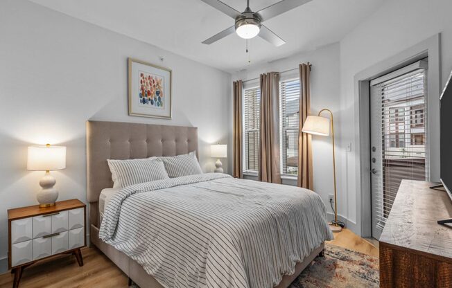 a bedroom with a bed and a ceiling fan