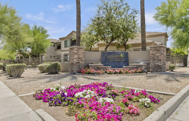 a garden with flowers and trees in front of a house at Adiamo Palm Valley, Goodyear, AZ