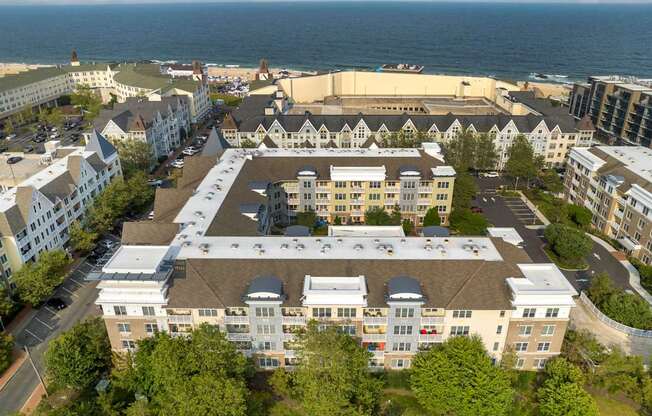 an aerial view of the building with the ocean in the background at Pier Village Apartments, New Jersey