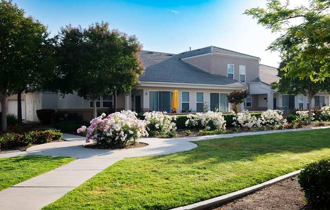 A residential area with houses and well-maintained gardens.