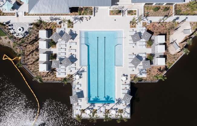 an aerial view of the pool and sundeck beside the pond at Lake Nona Concorde