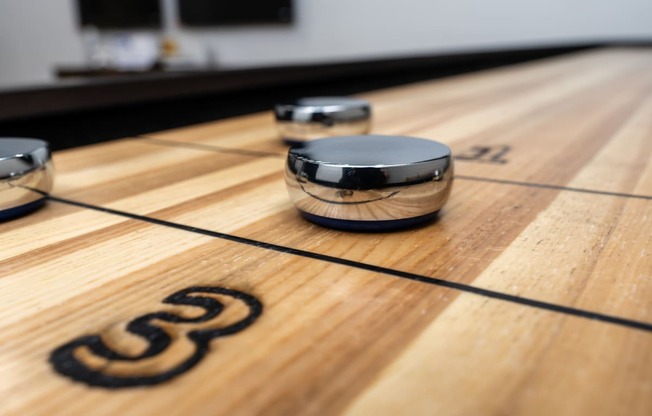 a row of shuffleboard balls on a wooden floor