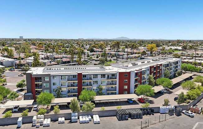 A large red and white building with a parking lot in front.