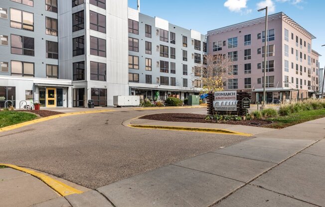a street view of a large apartment building with a sidewalk