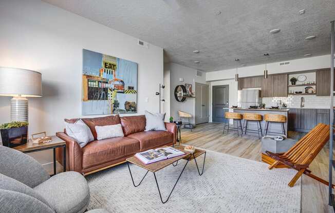 Shot of living room looking into kitchen with rug, and designed furnishings