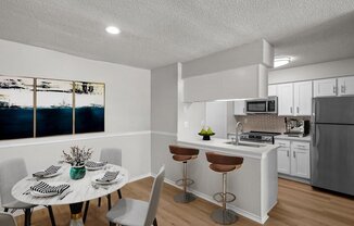 a kitchen and dining room with a table and chairs at Highland Park Apartment Homes, Overland Park