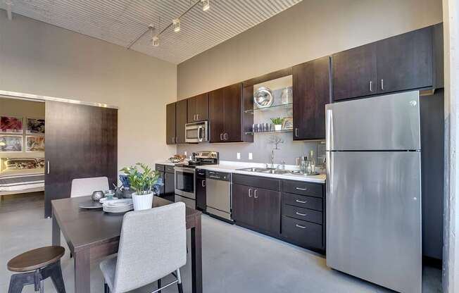 A modern kitchen with a dining table and chairs.