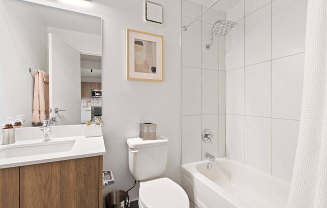 a white bathroom with a toilet sink and shower