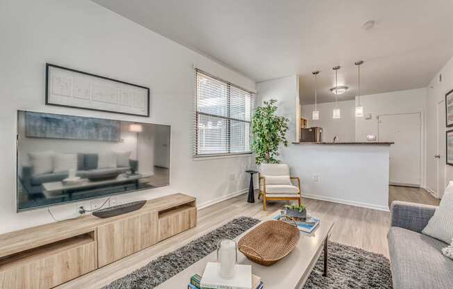 A living room with a television, a chair, and a table.