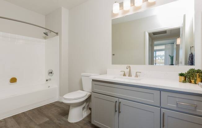 a bathroom with a sink toilet and a mirror