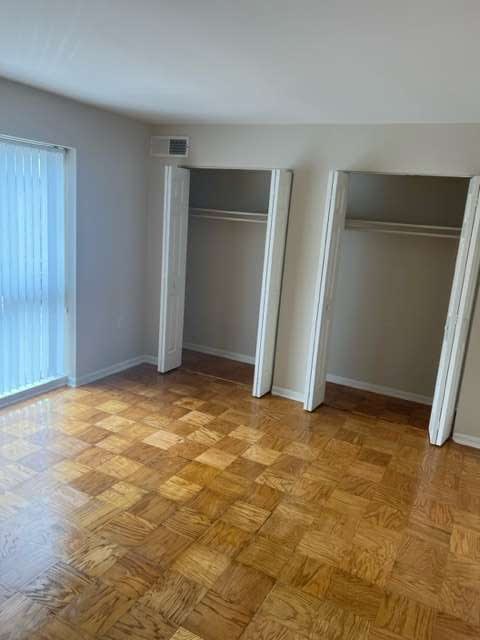 a empty room with a wooden floor and a window