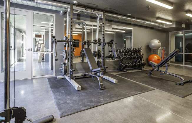 a fitness center with a smith machine at Lotus Republic Apartments for rent in Downtown Salt Lake City, Utah Lotus Republic Apartments for rent in Downtown Salt Lake City, Utah