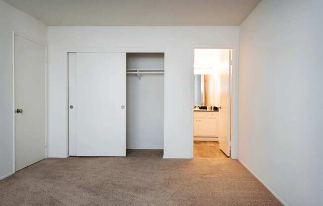 a bedroom with a carpeted floor and white walls
