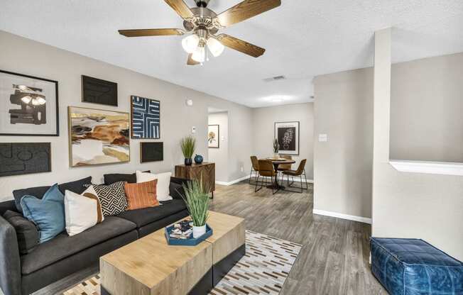 a living room with a couch and a ceiling fan