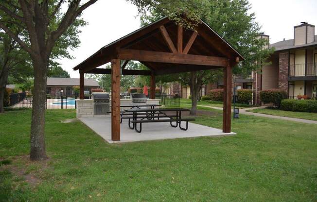 a pavilion with a picnic table in a park