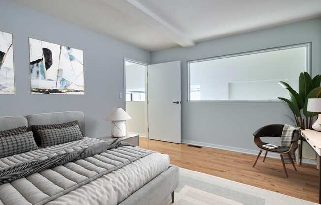 a living room with a couch and a chair and a window